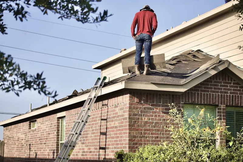 Professional roofer working on a residential roof in Town of Pecos